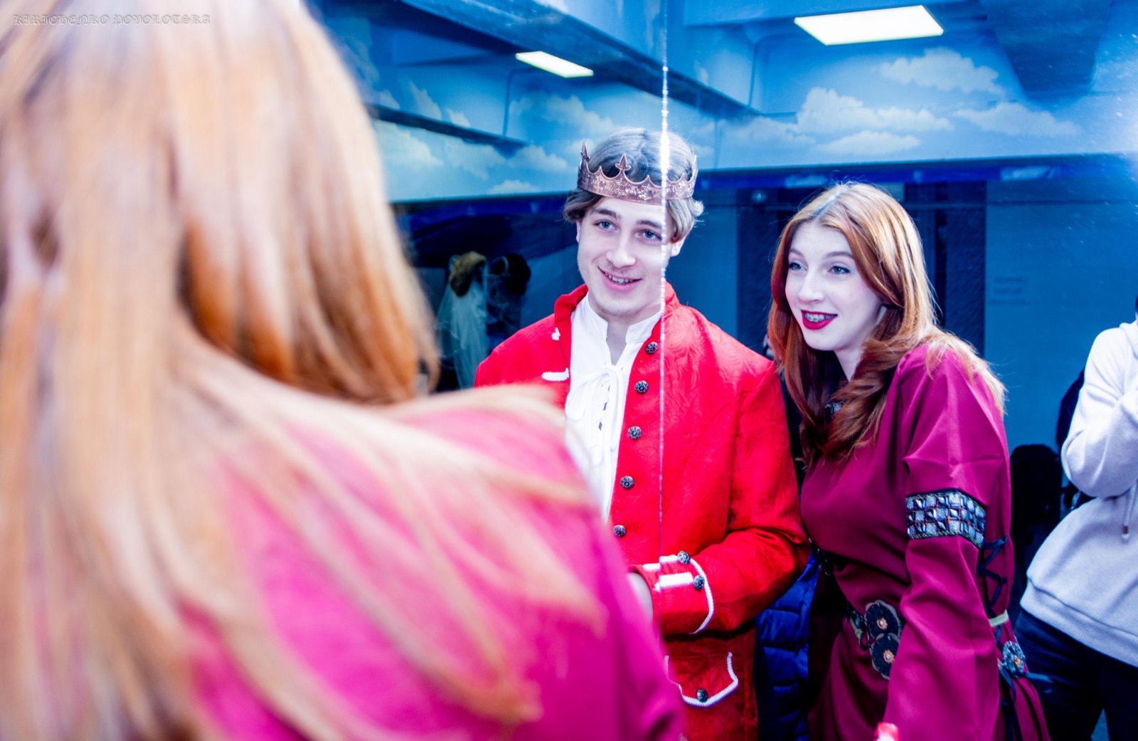 In a red costume and crown inside the Museum of Ukrainian Identity