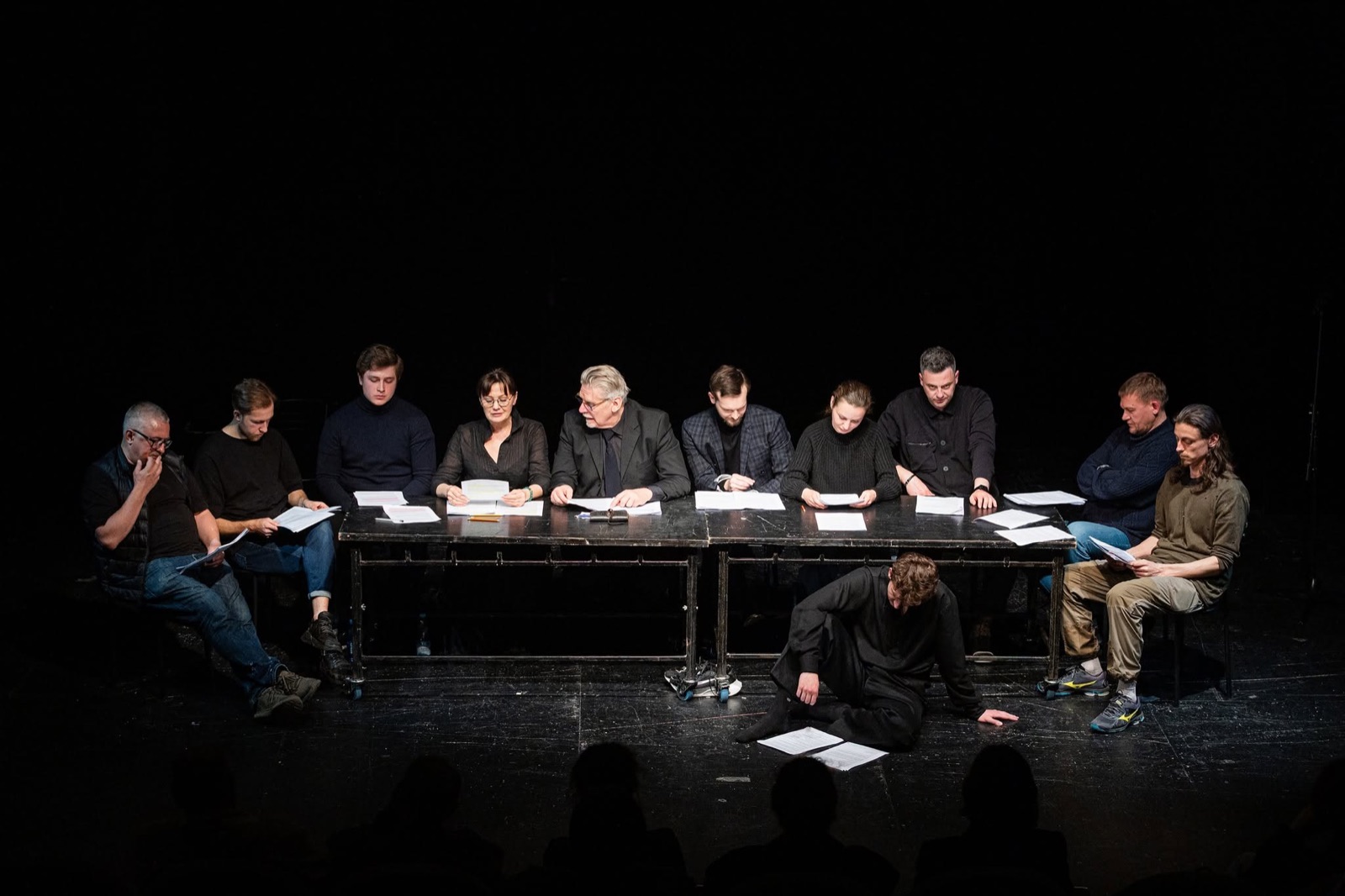 A staged reading at a long table
