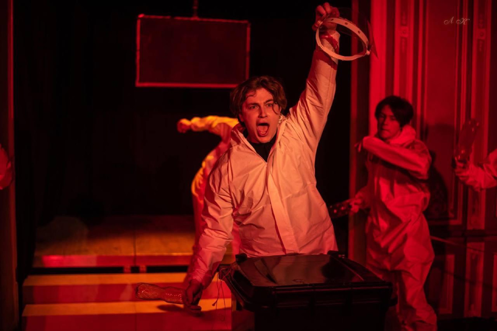Shouting under red light, holding a ring aloft