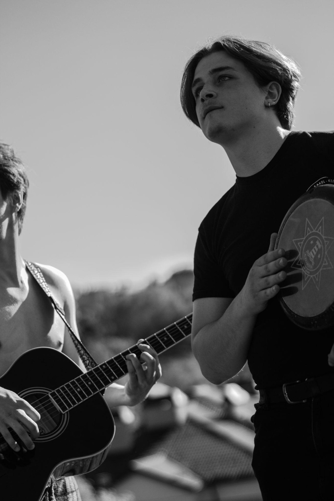 Jamming with a guitarist outdoors, black and white